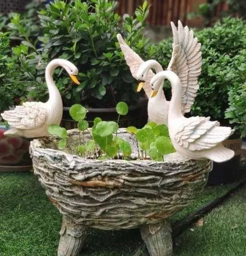 Resin flower pot with three white swans