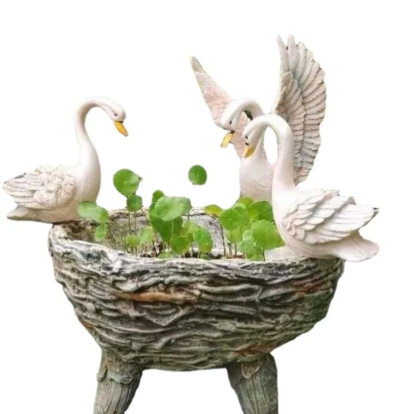 Resin flower pot with three white swans